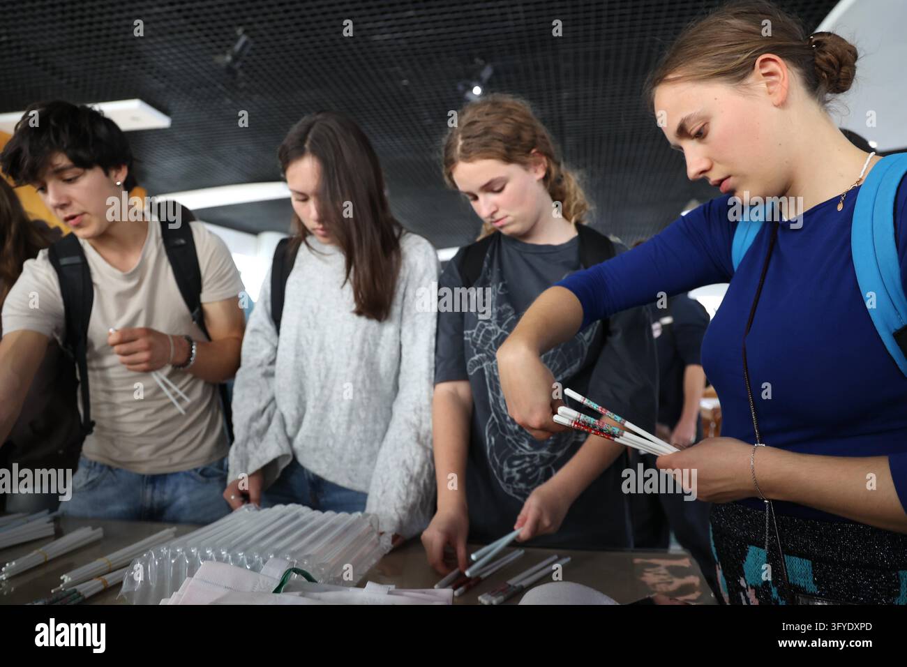 French teenagers select shell porcelain chopsticks at the Marine Shell ...