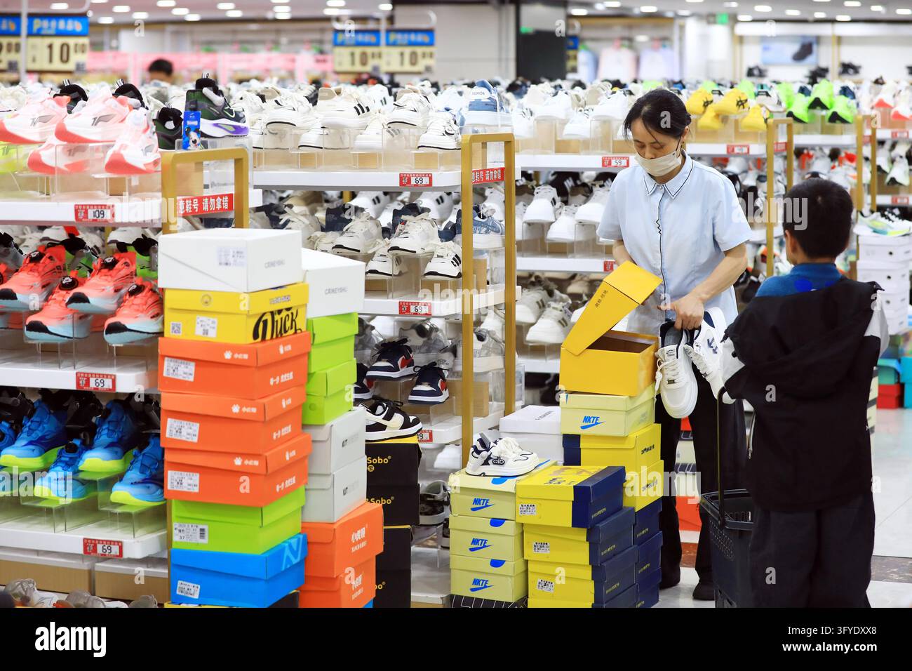 A resident shops at a supermarket in Huai'an, east China's Jiangsu ...