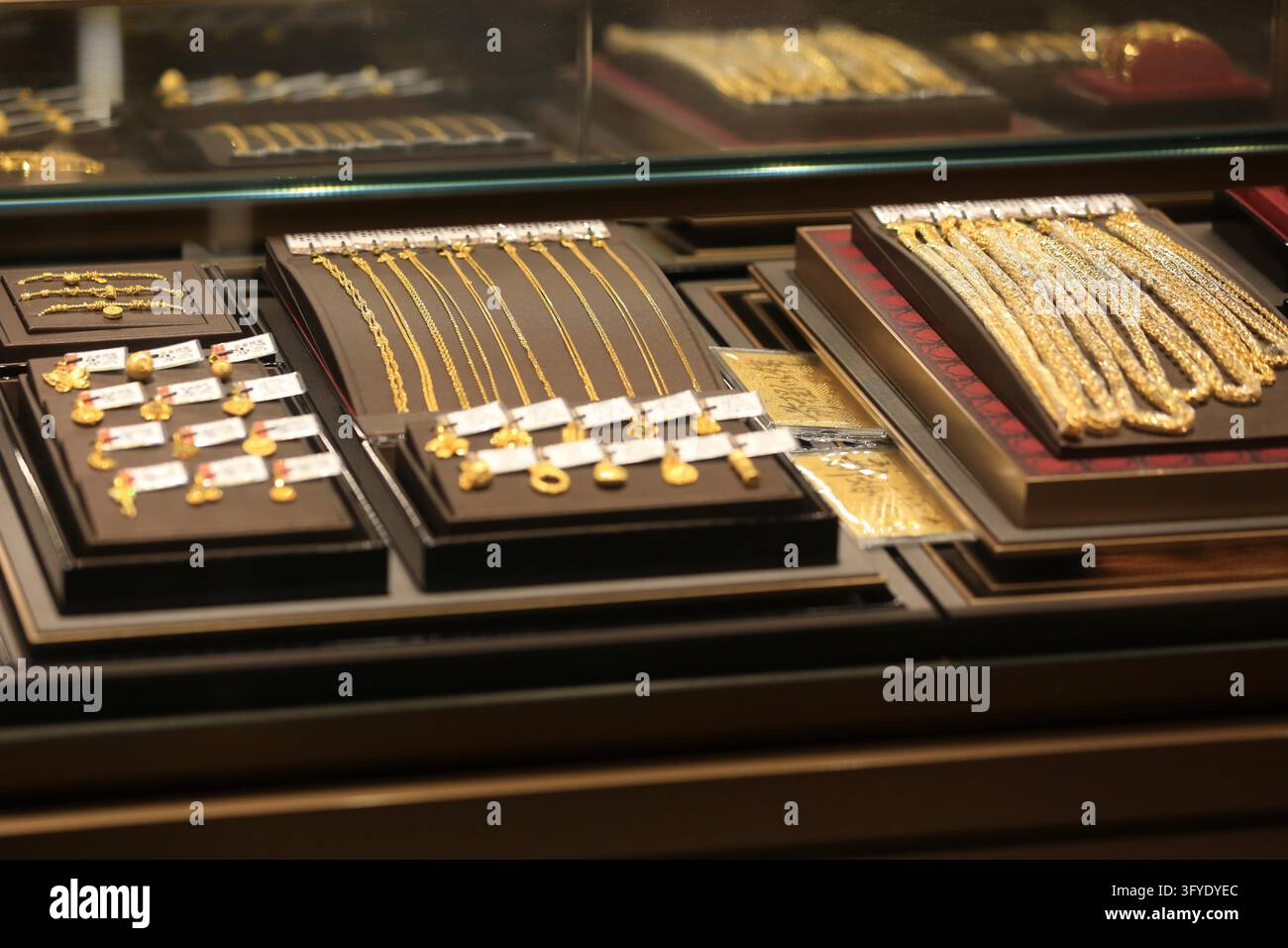 Consumers browse gold jewelry at a store in Huai'an, east China's ...