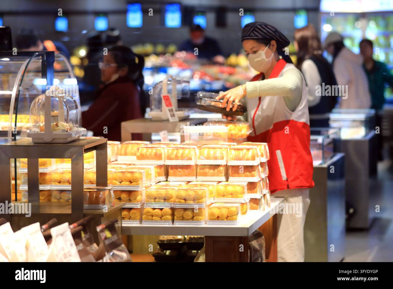 A resident shops at a supermarket in Huai'an, east China's Jiangsu ...