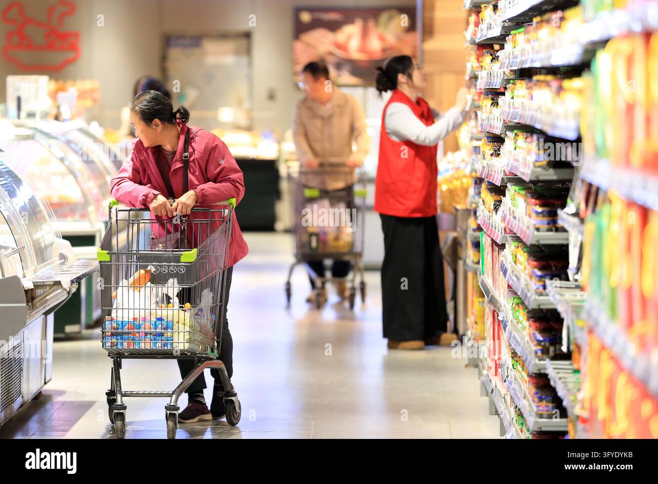 A resident shops at a supermarket in Huai'an, east China's Jiangsu ...