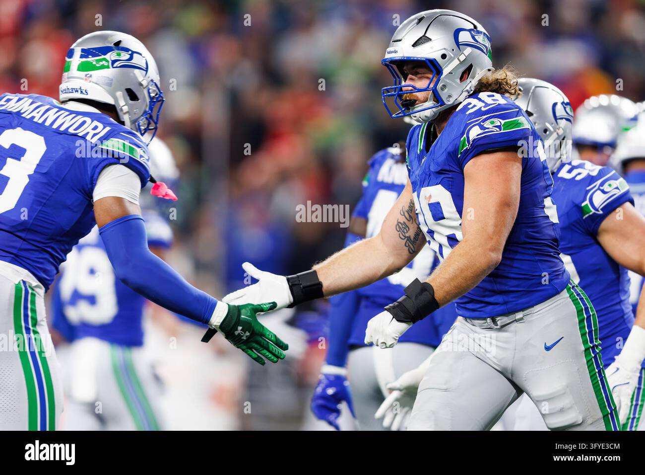 Seattle Seahawks fullback Brady Russell (38) high fives safety Nick ...
