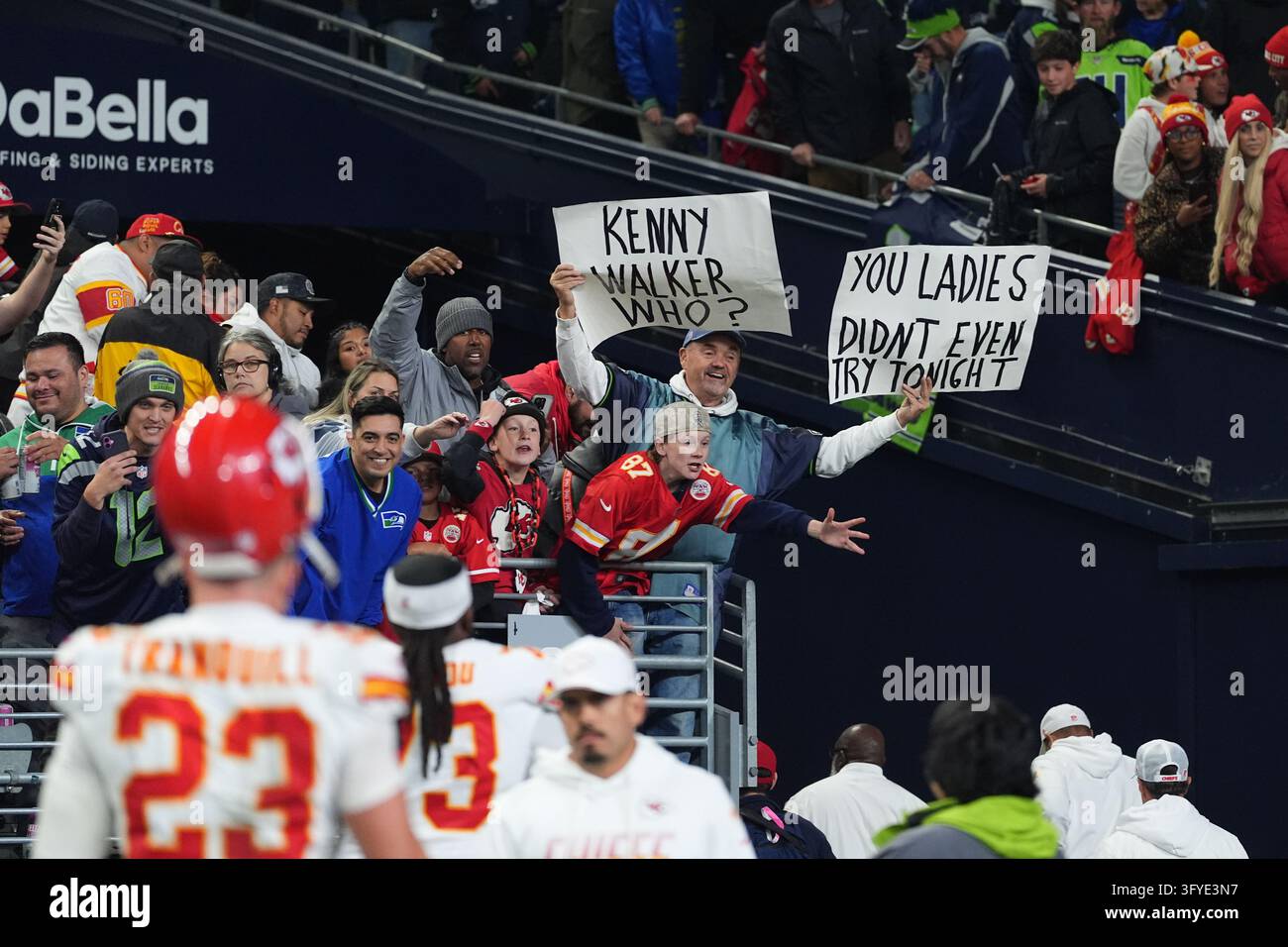 A fan holds up signs as the Kansas City Chiefs leave the field after ...