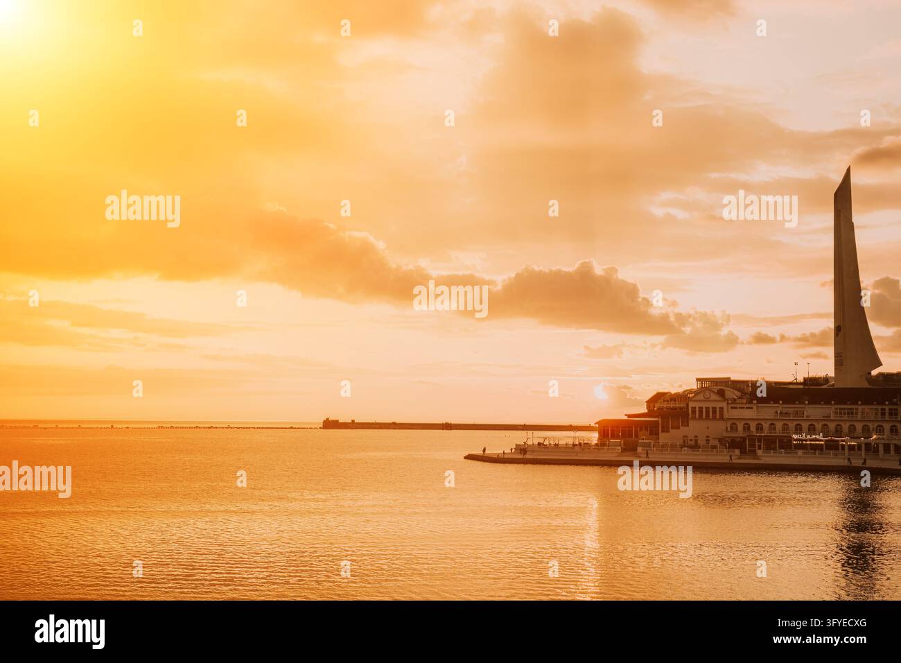 Sunset ocean architecture White buildings and monument line the ...