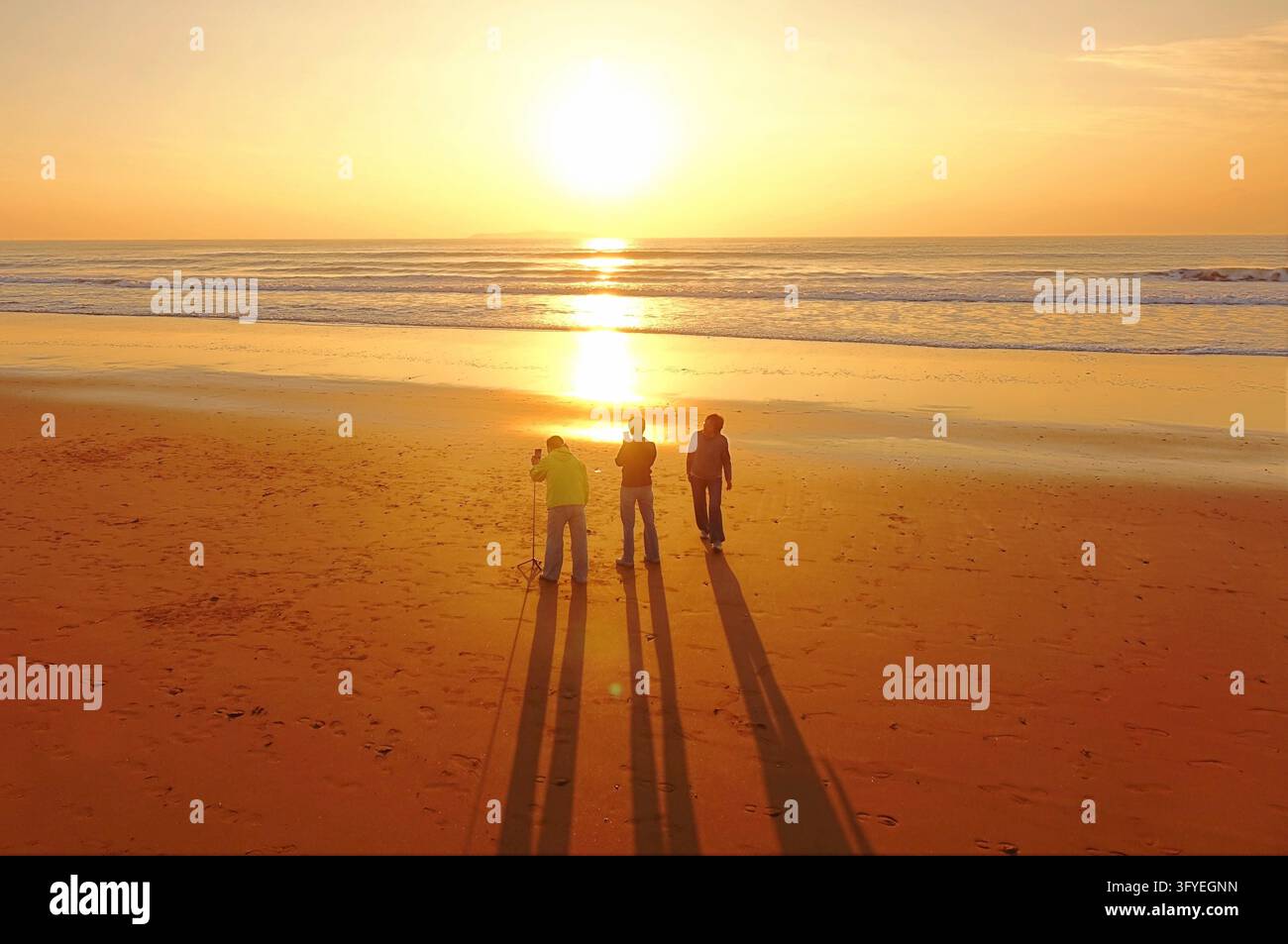 Tourists gather at Golden Beach to watch the sunrise and enjoy the sea ...