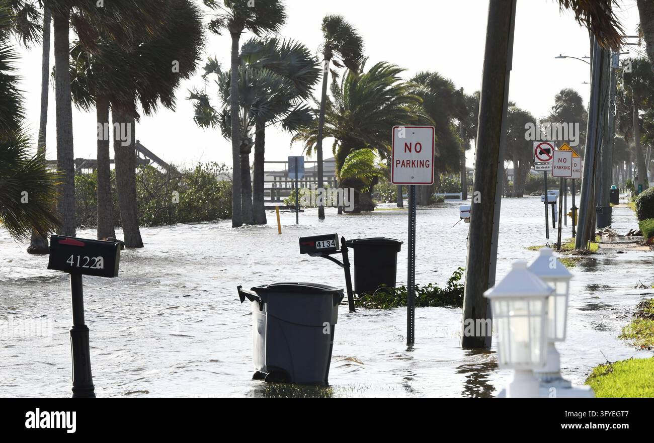 The Halifax River floods a street as well as boat docks, the result of ...