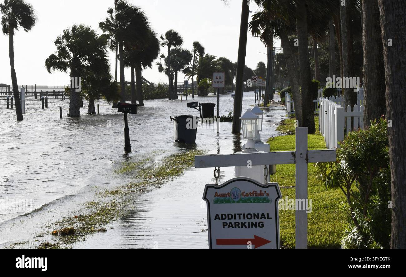 The Halifax River floods a street as well as boat docks, the result of ...