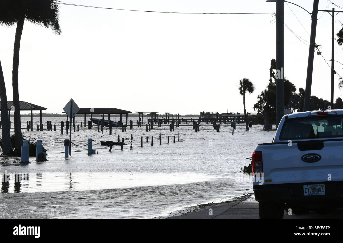 The Halifax River floods a street as well as boat docks, the result of ...