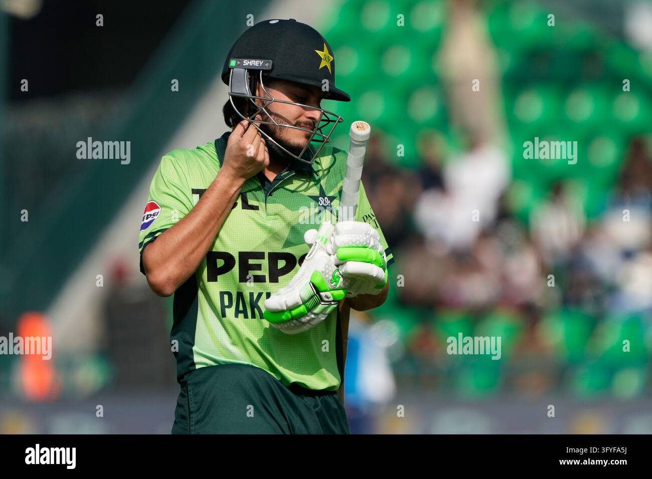 Pakistan's Saad Baig walks off the field after losing his wicket during ...