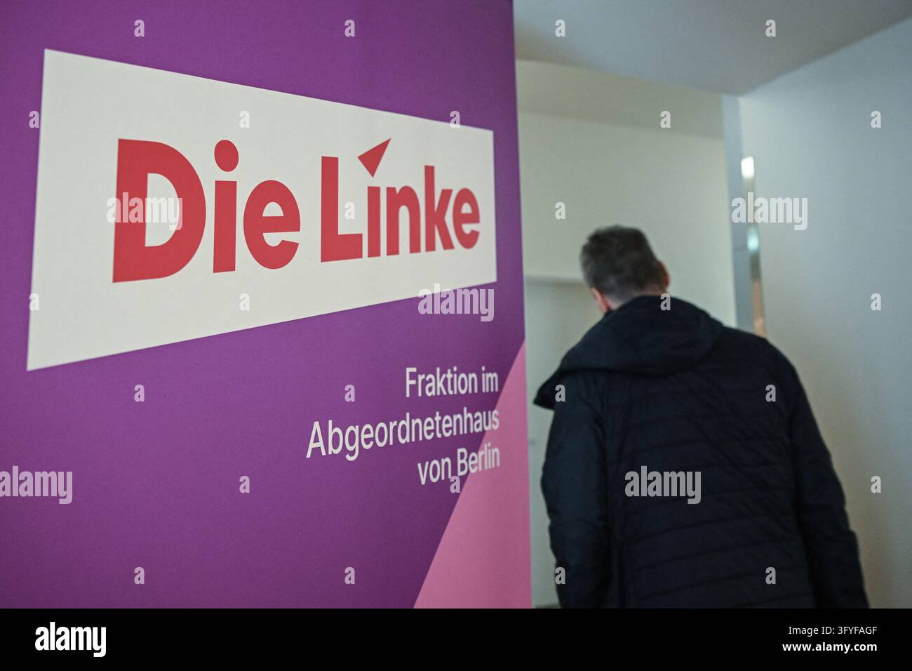 27 October 2026, Berlin: A man walks past a display set up by the Left ...