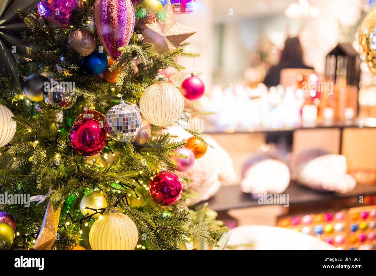 Colorful Christmas tree decorated with shiny baubles, stars and warm ...