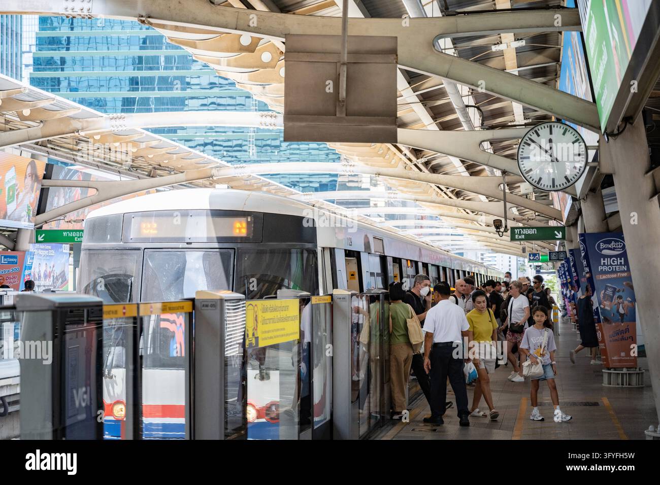 Passengers seen exiting a Bombardier Innovia Monorail 300 on the mass ...
