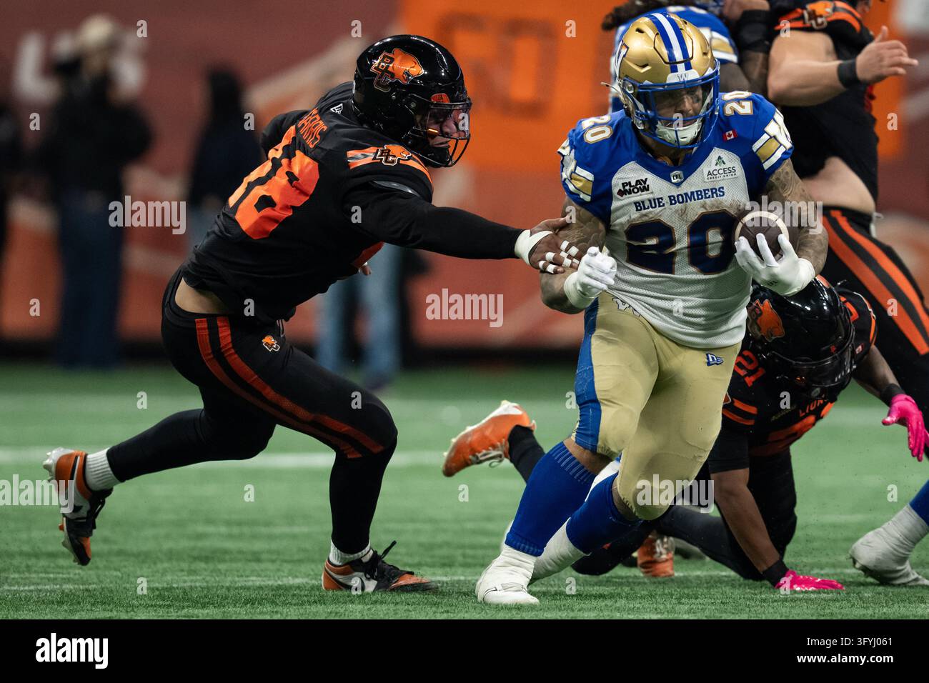 Winnipeg Blue Bombers' Brady Oliveira (20) slips B.C. Lions' Hayden ...