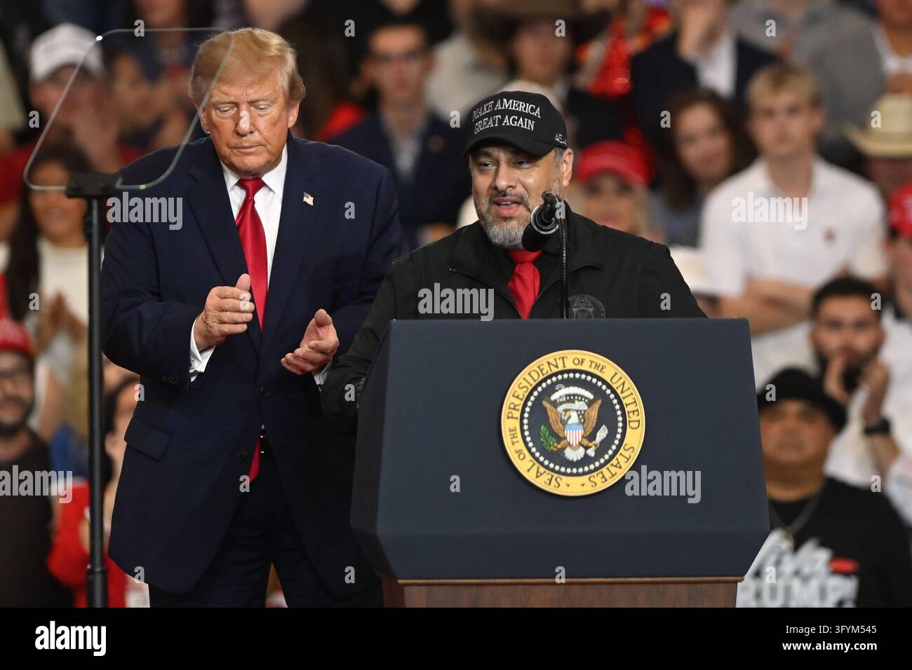 President Donald Trump listens as Paul Perez, president of the National ...