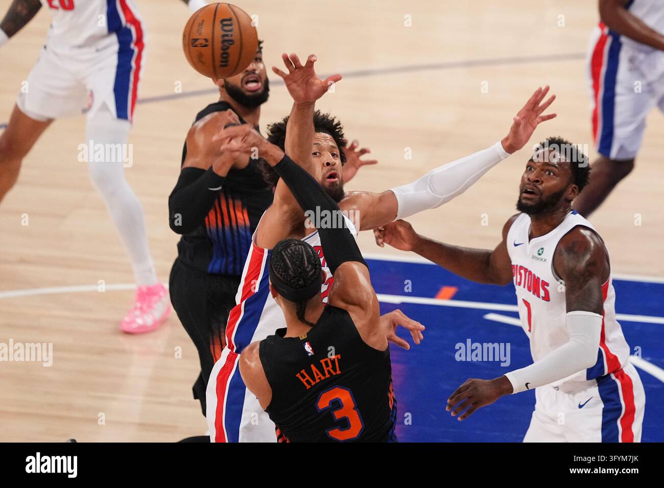 Detroit Pistons' Cade Cunningham, center, defends a pass by New York ...