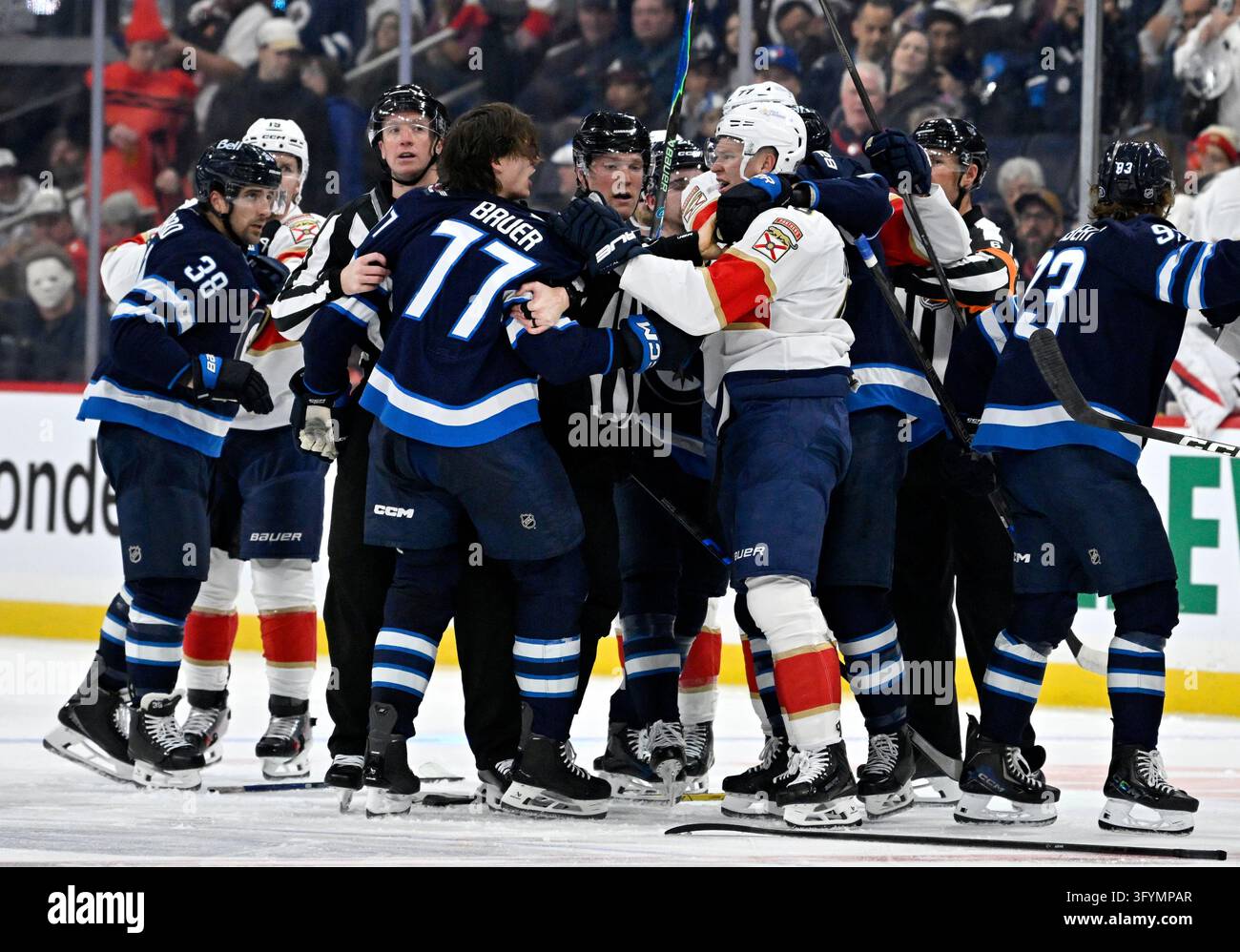 Winnipeg Jets' Tyrel Bauer (77) and Florida Panthers' Brady Tkachuk (8 ...
