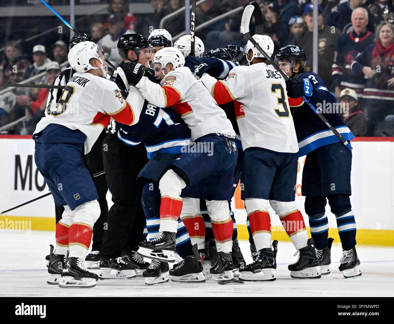Winnipeg Jets' Tyrel Bauer (77) is grabbed by Florida Panthers' Brady ...