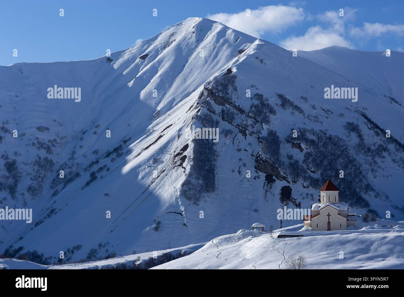 Traditional white Georgian orthodox church standing on a snow-covered ...