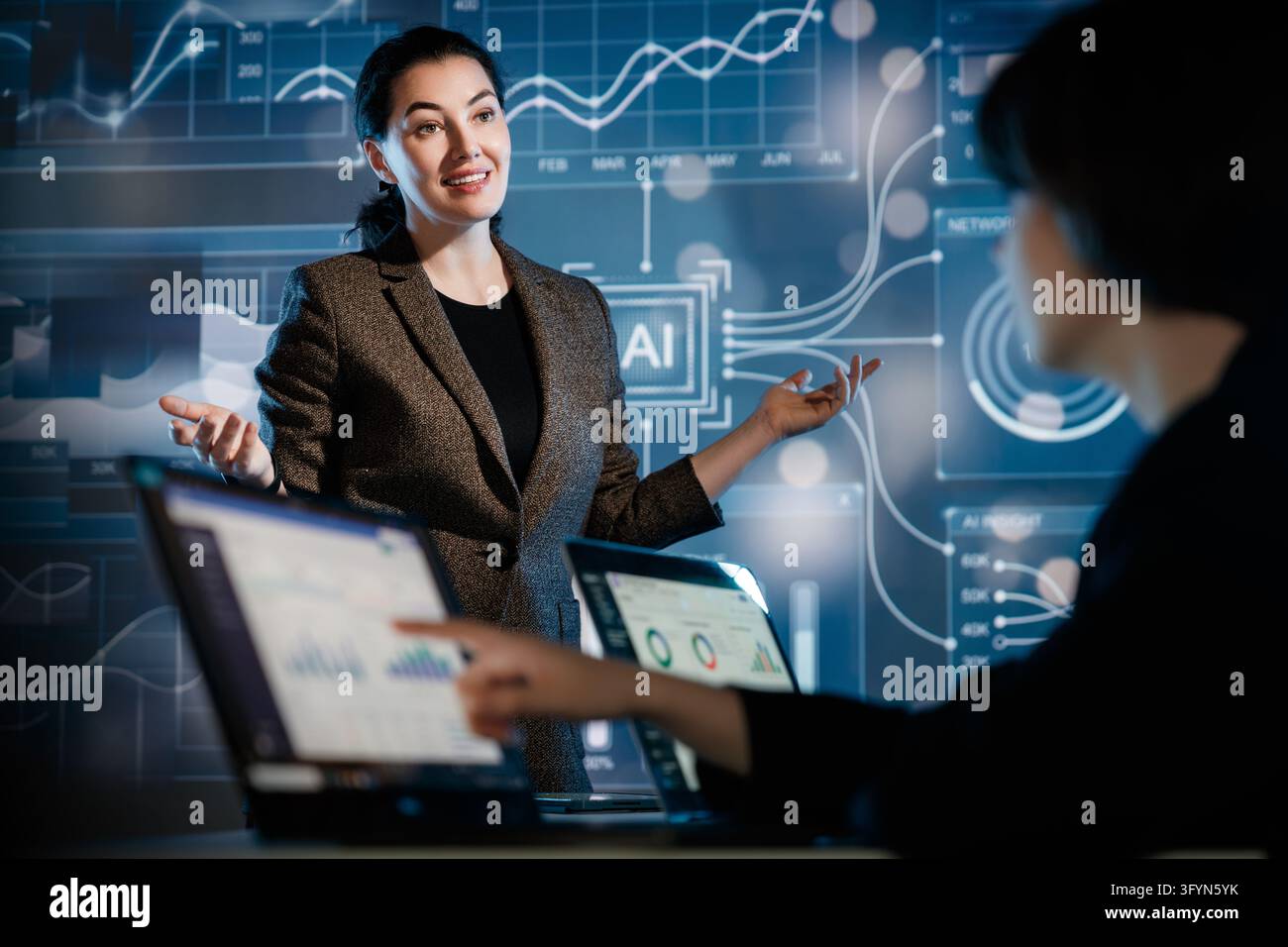 Professional businesswoman engaging a diverse team in a high-tech ...