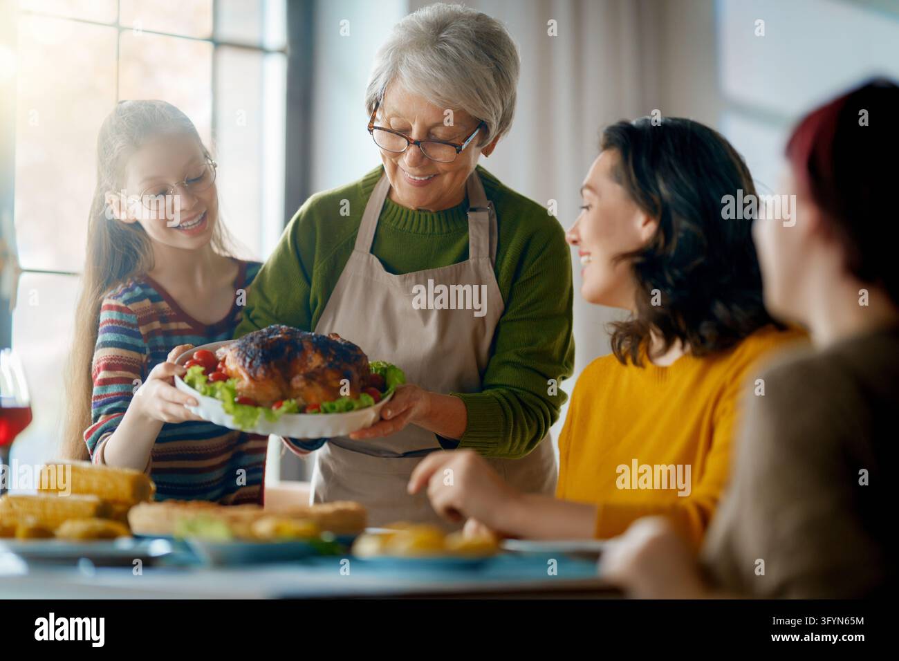Smile Purchasing Joyful multi-generational family enjoying a holiday meal together in a ...