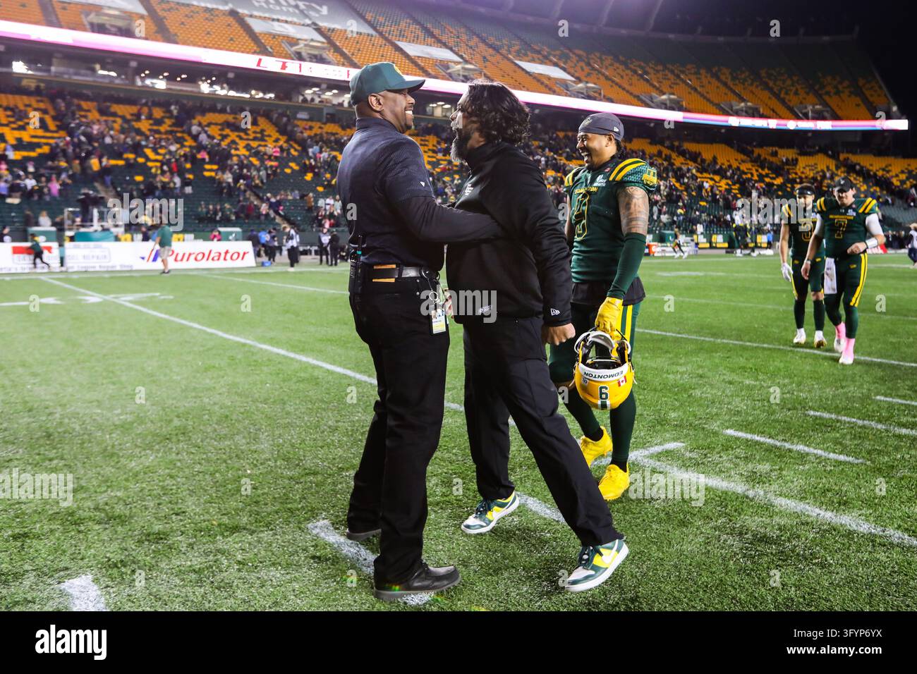Team Hug Vector Edmonton Elks general manager Ed Hervey, left, hugs head coach Mark ...