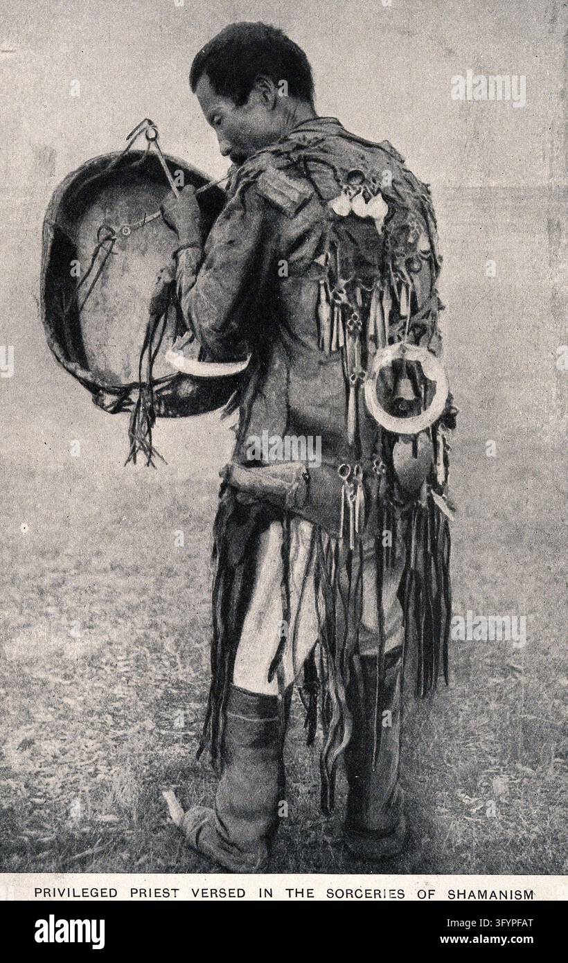 A shaman with drum and in full costume. Process print Stock Photo - Alamy