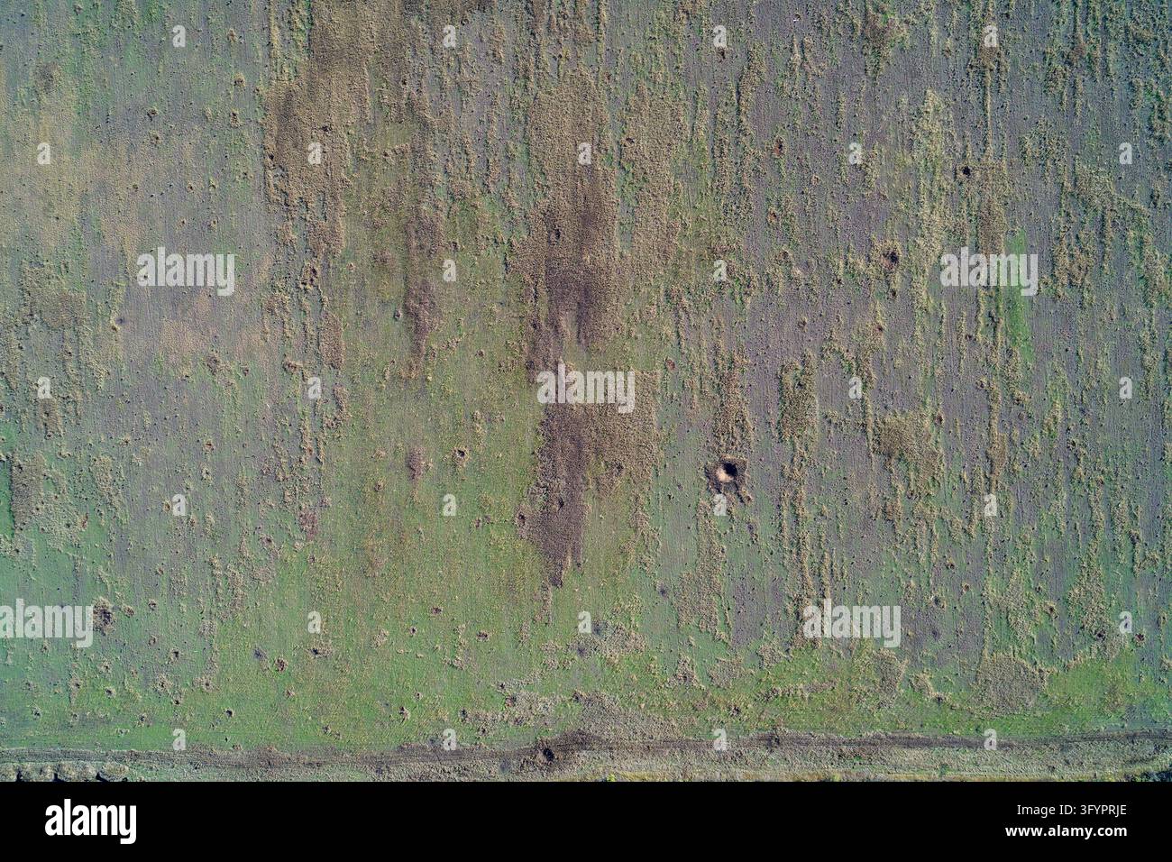 Textured agricultural field pattern seen from above, showing plowed ...
