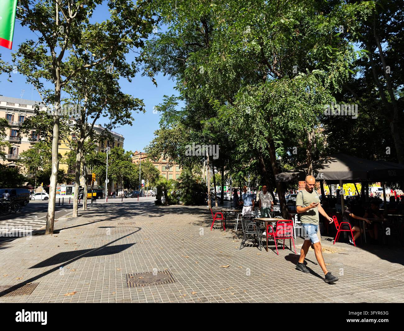 Barcelona , Spain - June 27, 2026: Barcelona man walks through a square ...