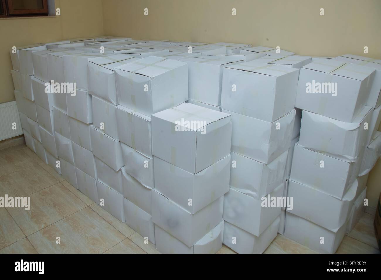 Stacking Cargo Signage Large stack of white cardboard boxes stored inside a warehouse room ...
