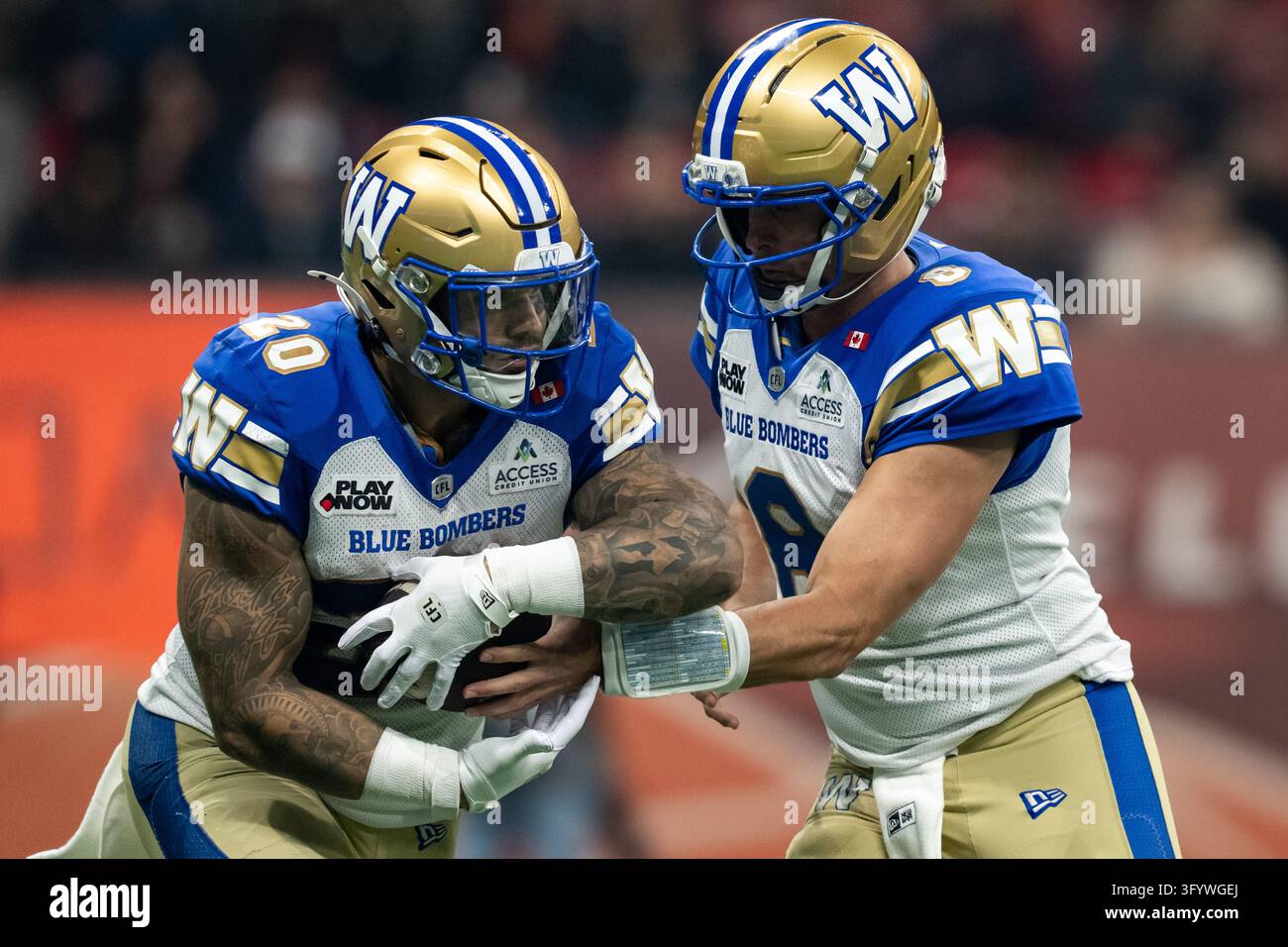 Winnipeg Blue Bombers quarterback Zach Collaros (8) hands the ball to ...