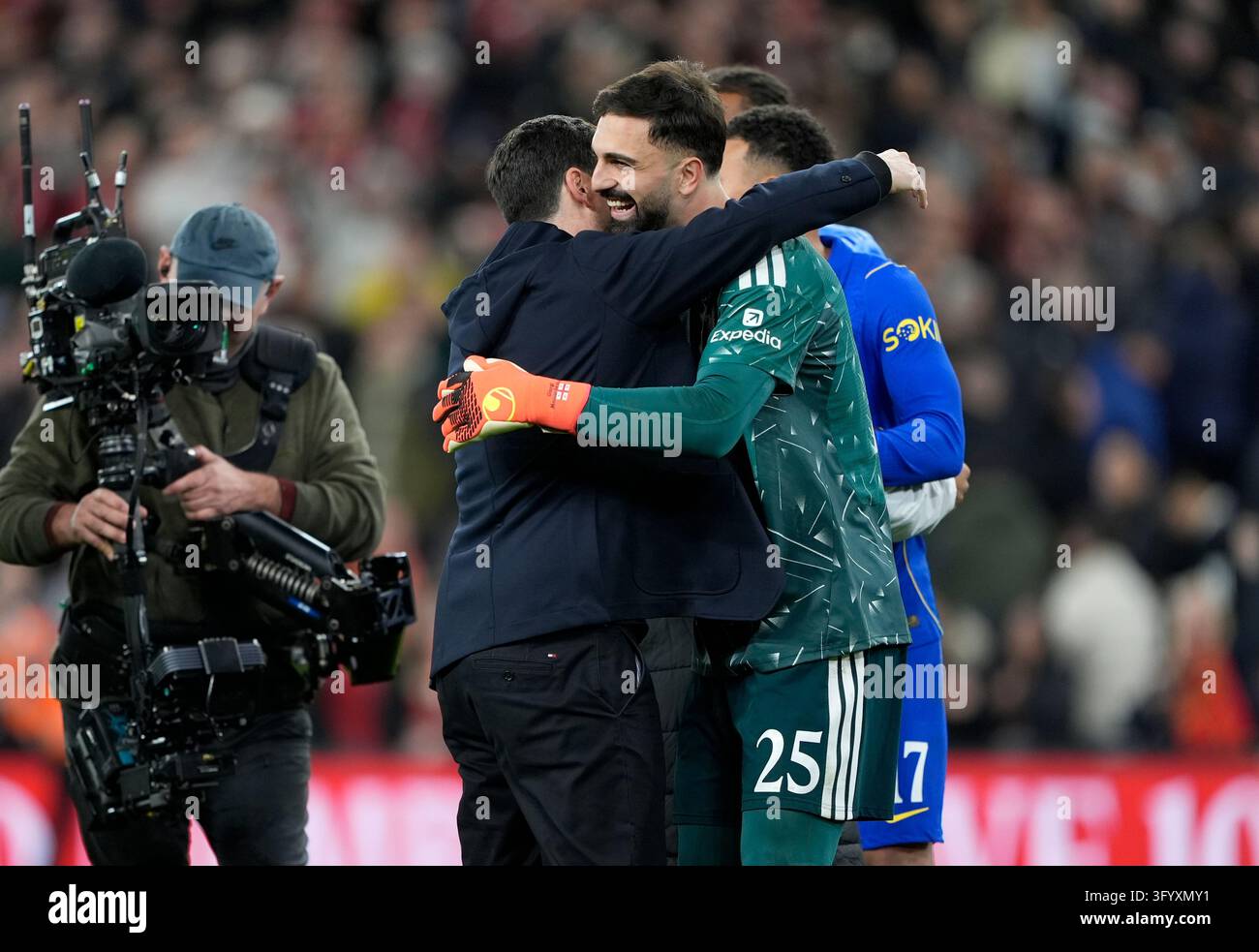 Team Hug Vector Liverpool manager Andoni Iraola (left) hugs goalkeeper Giorgi ...