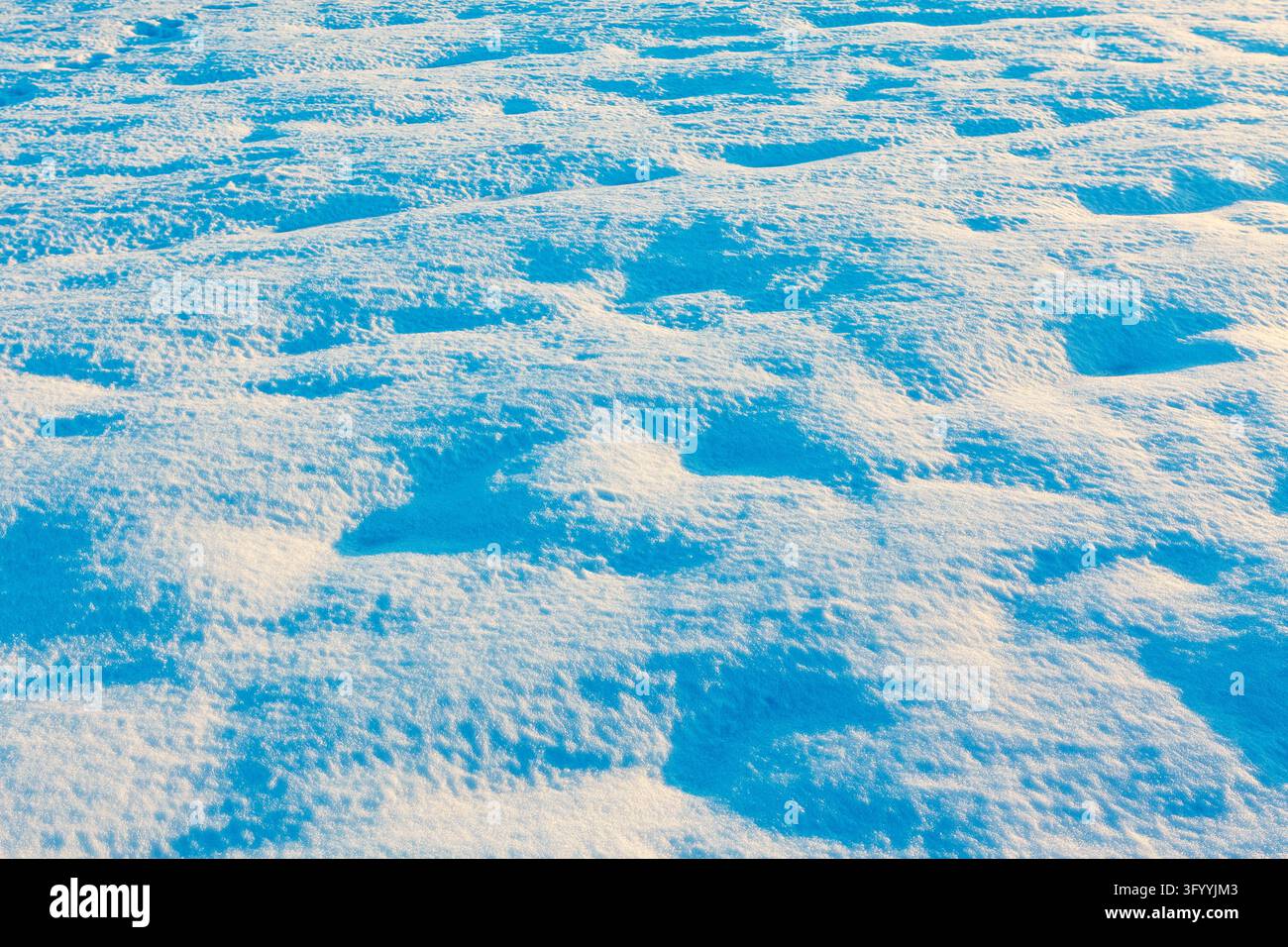 Superficial Ridges Textured blanket of snow covers the landscape from above. Sunlit ridges ...