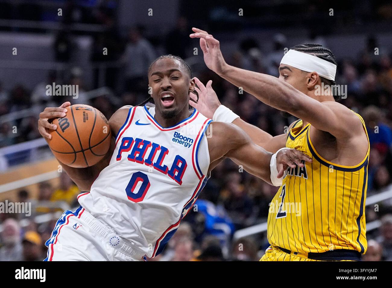 Philadelphia 76ers guard Tyrese Maxey (0) holds off Indiana Pacers ...