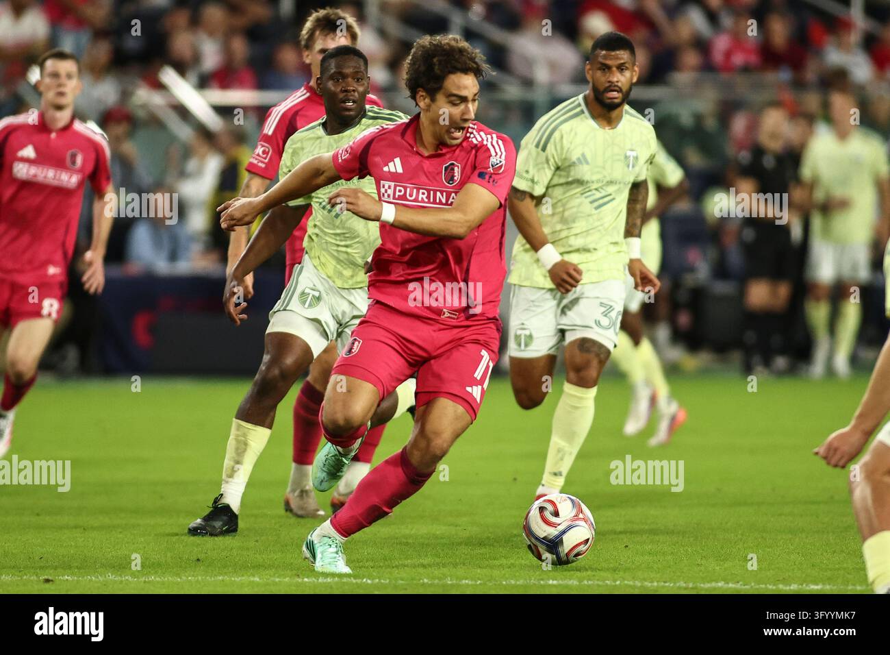 Between The Box Simon Becher (11) of St. Louis City SC beats Timber FC players to make ...