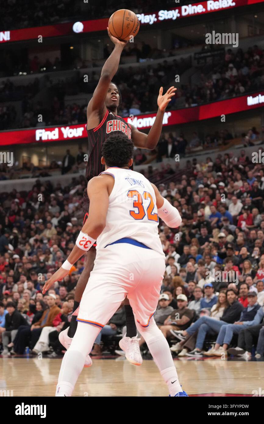 Chicago Bulls forward Caleb Wilson (top) shoots the ball over New York ...