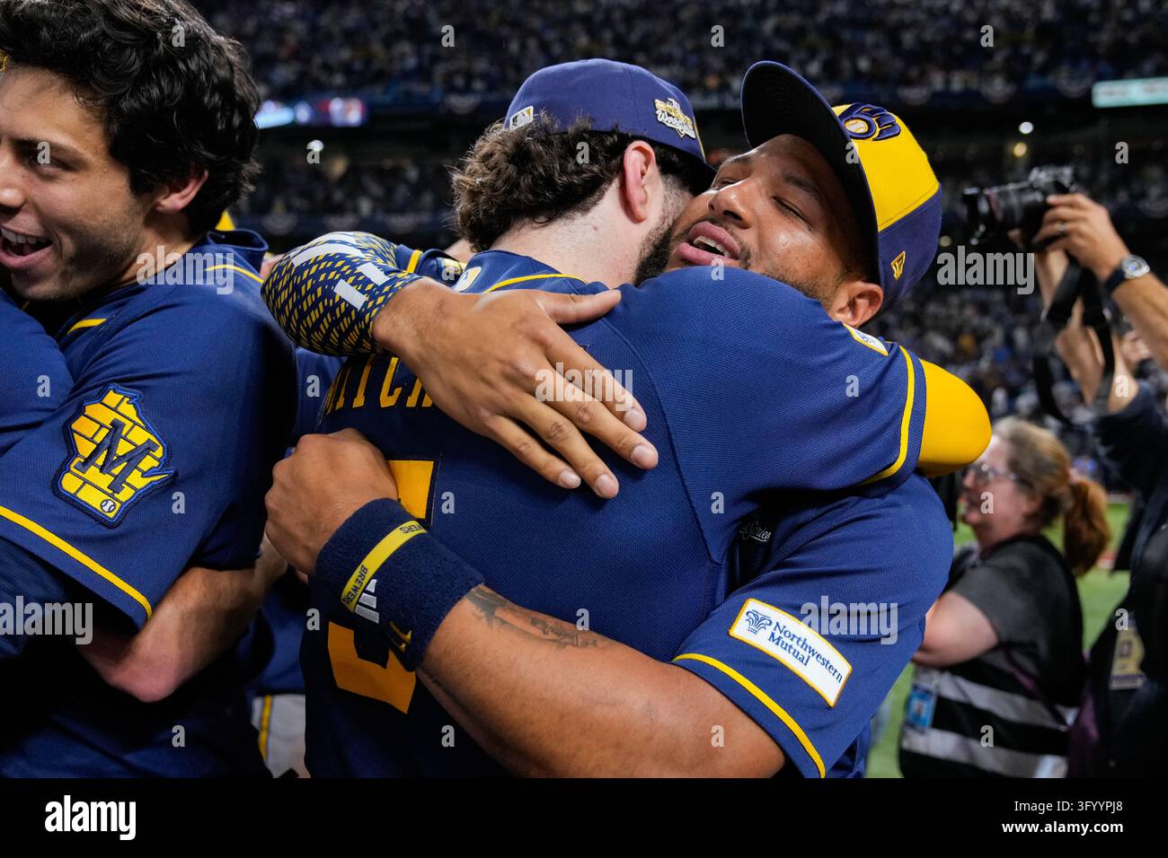 Team Hug Vector Milwaukee Brewers'Jackson Chourio, right, hugs teammate Sal Frelick ...