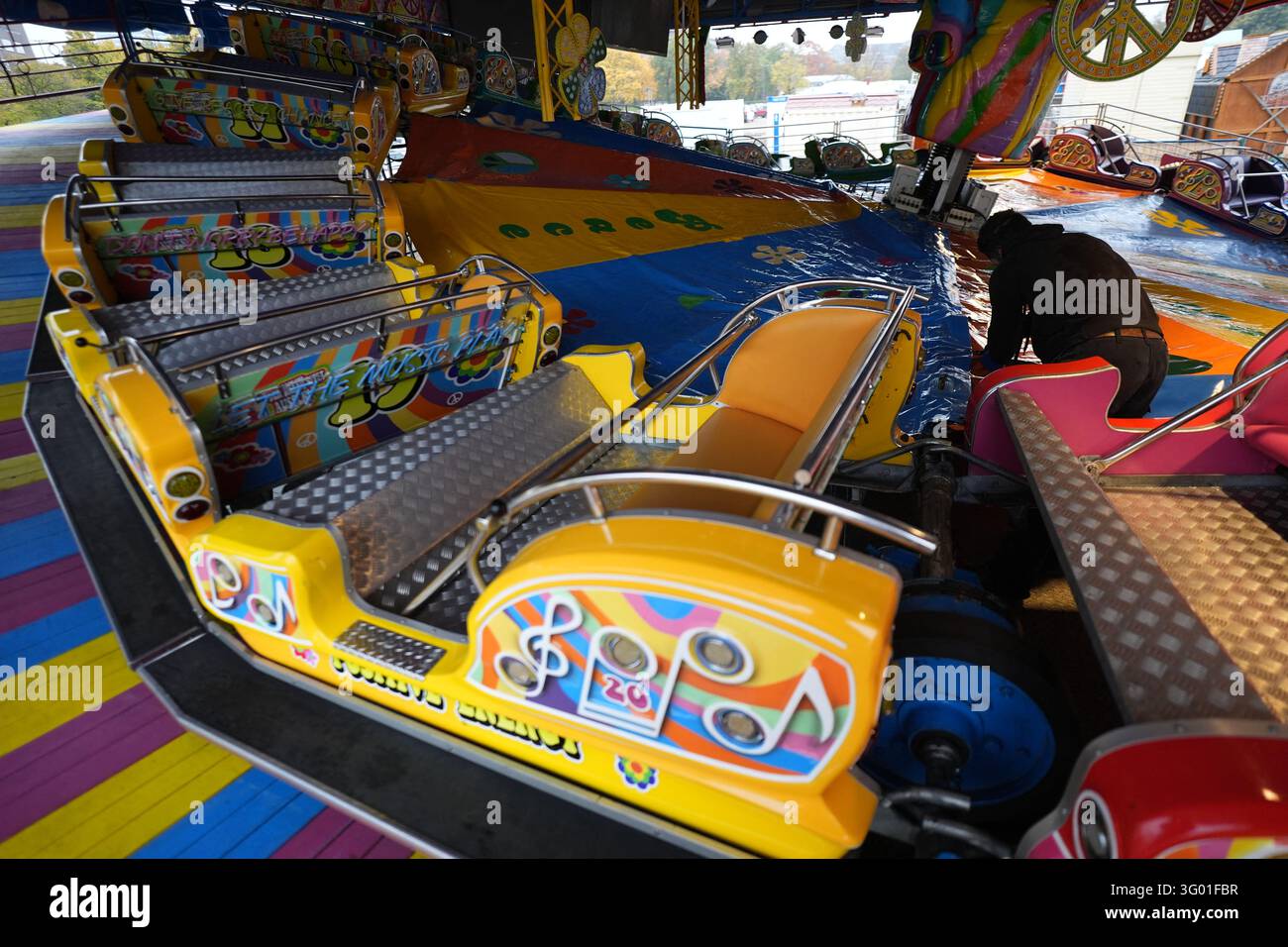 29 October 2026, Hamburg: An employee is checking the setup of a ride ...