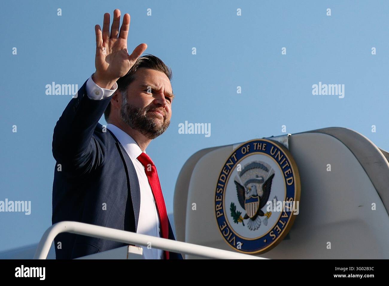 Pool Wiver Vice President JD Vance waves before boarding Air Force Two for Texas ...