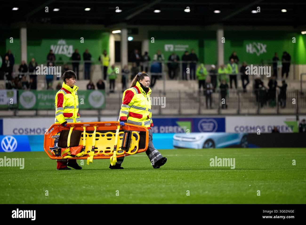 Paramedics carry a stretcher for an injured player onto the pitch ...