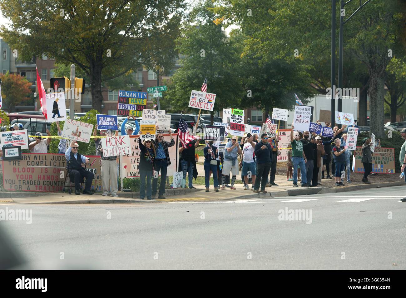 Protesters No Signs Protesters wave signs as the motorcade for President Donald Trump ...