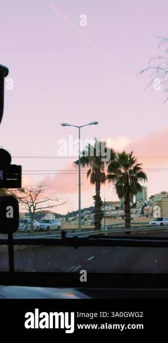 sunset view from bus window on city and road. public transport, bus in ...