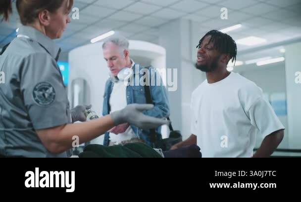 Airport Security Checkpoint: Female Security Officer Checking Suitcase 