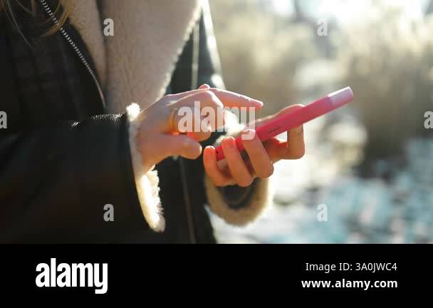 A young lady using a mobile phone outdoors. High quality FullHD footage Stock Video Footage - Alamy