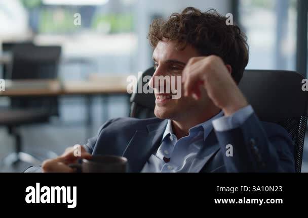 Smiling worker drinking coffee resting at panoramic cabinet portrait ...