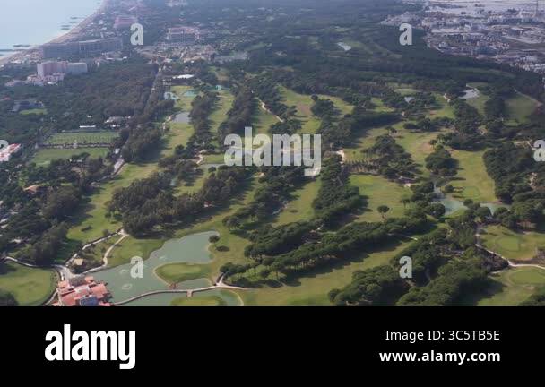 Aerial view of a lush green golf course with fairways, ponds, and sand ...