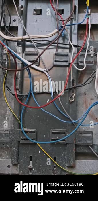 Close-up look into an open electric box, focusing on colorful wires ...