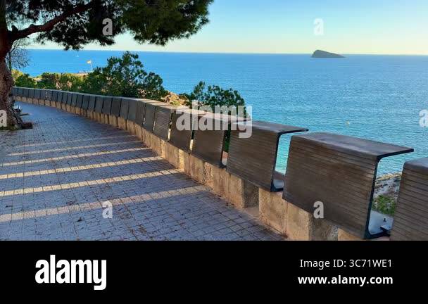 A beautiful coastal pathway with benches, offering stunning views of ...