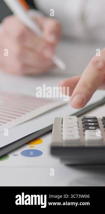 A skilled professional reviews financial documents, making insightful ...