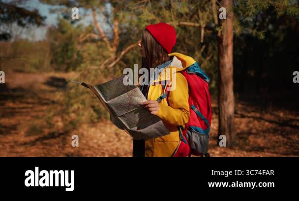 Backpacker hiker girl with hiking - Backpacker Hiker Girl With Hiking Poles Using Authentic Paper Map In The Forest Hispanic Teenager In The Woods 3c74far