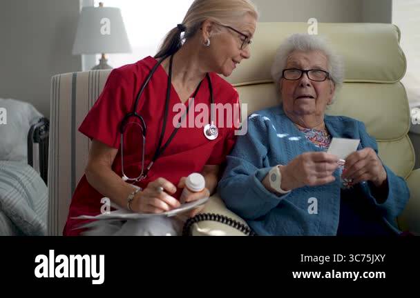 A nurse in scrubs interacts warmly with an elderly resident, sharing a ...